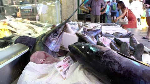 Venice, Italy-20 September, 2018: 4K, Fishmongers selling fresh fish, including giant swordfish, traditional market of Rialto. Italian vendors sell food in street stand near of Grand Canal-Dan 