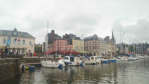 HONFLEUR, FRANCE - AUGUST, 2018: Honfleur harbour old port with beautiful houses and lots of yachts.