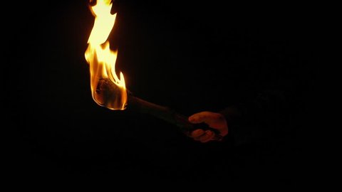 Man Holds Up Fire Torch At Night
