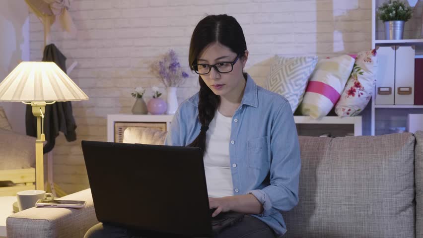 slow motion annoyed girl in glasses shut down laptop. mad businesswoman sitting in sofa looking at laptop screen with angry expression. Too much workload file error data failed forgot save document Royalty-Free Stock Footage #1021437781