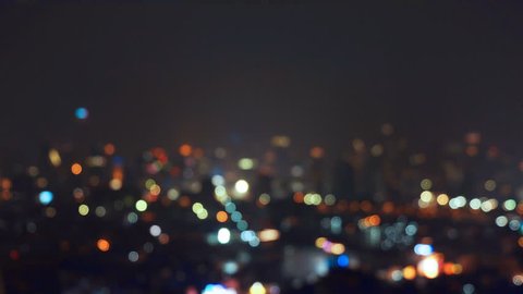 Bokeh background of skyscraper buildings in city with lights, Blurry photo at night time. 4K cityscape 