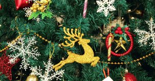 Tilting video of beautiful Christmas tree decorated by gorgeous ornaments, concept for Christmas time.

