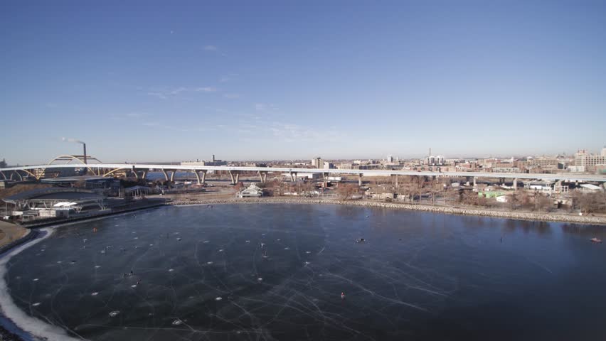 Aerial view of winter ice fishing on a frozen lakeshore state park inlet lake.