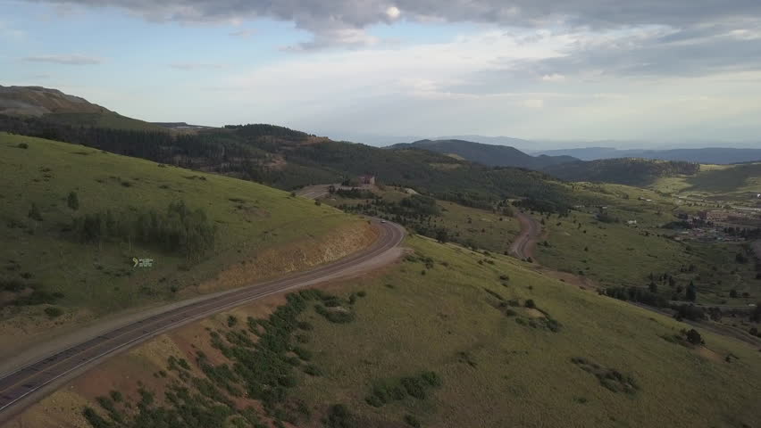 Drone View of an Empty, Winding Highway Cutting Through the Mountains and Valleys of Colorado