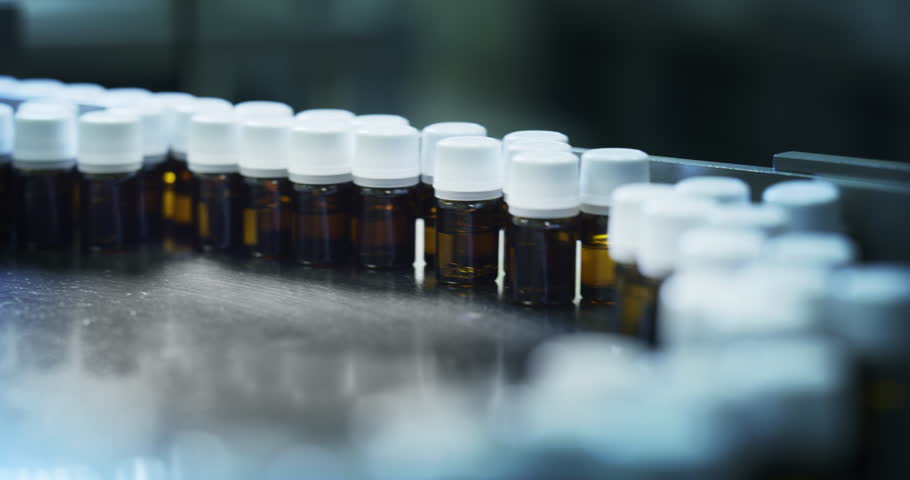 Close up of production of medicines in glassware bottles on automatic lines in a pharmaceutical factory. Shot in 8K. Concept of healthcare, pharmaceutical industry, medicine production Royalty-Free Stock Footage #1021446406