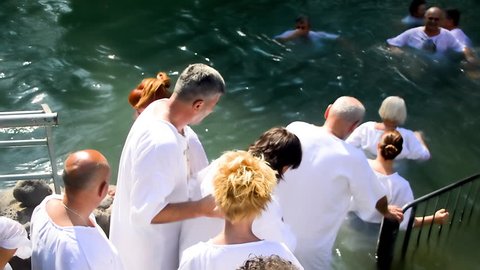 RIVER JORDAN, JERUSALEM, October 04 2018: People on baptism ceremony at river Jordan in Israel.
