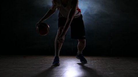 Sportsman playing basketball in basketball court