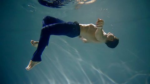 Underwater shot of a man underwater in pants float up youth activities teen adventure active lifestyle Hobby