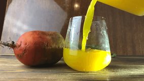 yellow beet juice in glass on  table