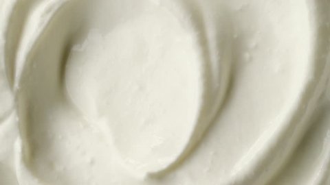 rotating swirl of sour cream or yogurt macro