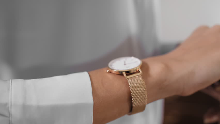 gold watch on wrist