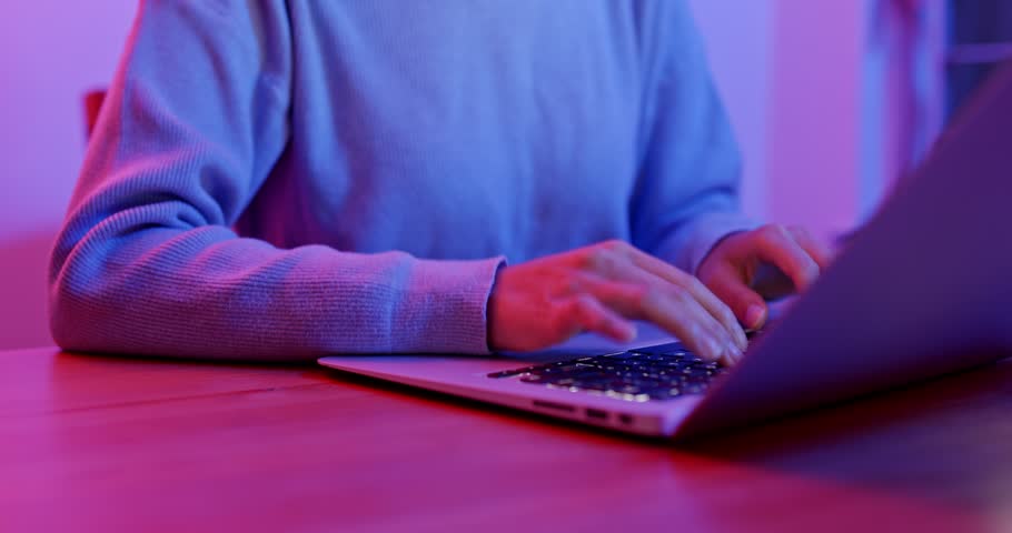 Woman type on keyboard at home