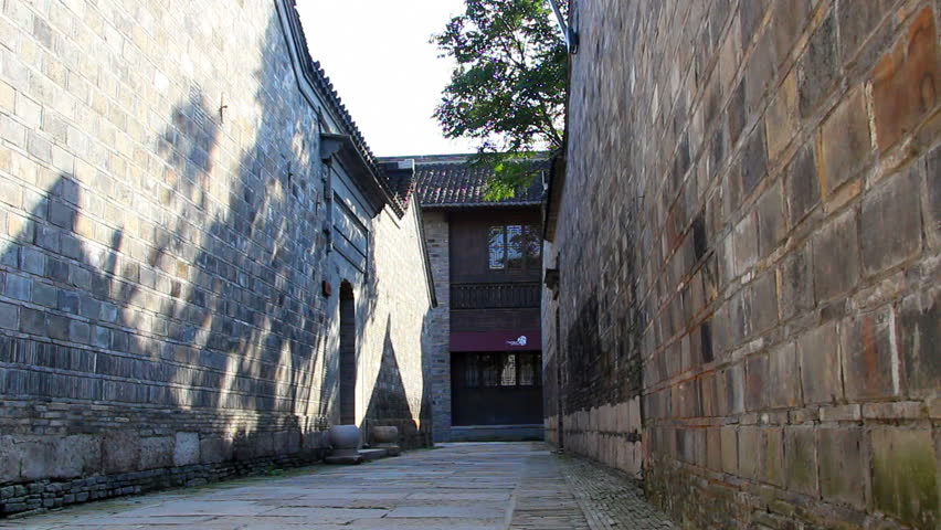 sunlights and shadow of swaying tree branches on the wall  