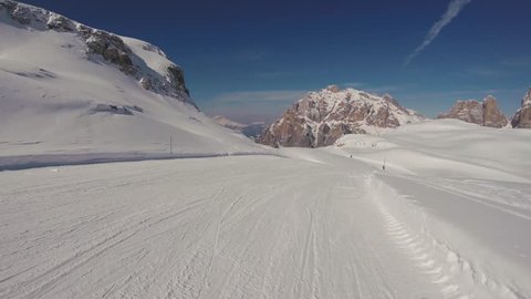 A skier skiing on the scenic tracks in Alps mountains, action camera footage