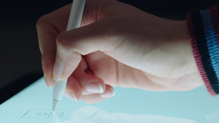 close up hand using digital tablet drawing with stylus pen graphic designer sketching planning layout on mobile touchscreen device