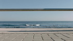 woman legs walking barefoot on seaside pier enjoying relaxing summer vacation watching beautiful ocean