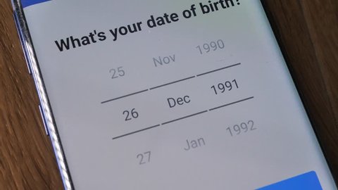 Providing personal information for age verification over smartphone app by using scroll menu with the title "What's your Date Of Birth?"