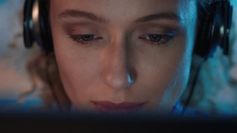 close up portrait beautiful woman using tablet computer browsing online enjoying listening to music wearing headphones