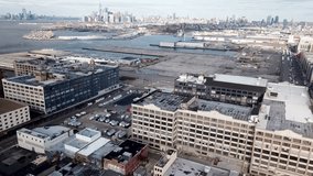 Aerial drone footage video from SunSet Park and Red Hook in Brooklyn with abandoned pierses and factories