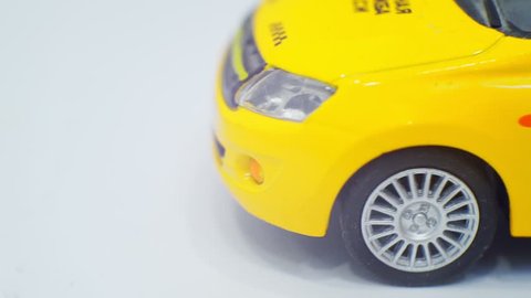 small toy yellow taxi car rides and stops.Close-up.Macro shot.business concept.Taxi.transportation of passengers.