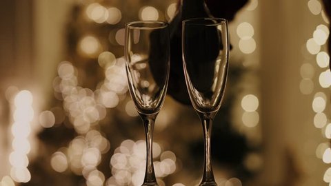 New years eve celebration background with champagne. man pours champagne into a glass. New Year 2020. New Year's mood. 4K