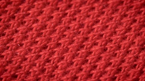 Red cotton fabric with polyester, which is used for sewing polo shirts. Weave a pike. Macro shoot. Close up.