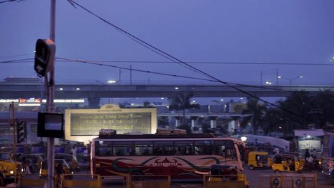 CHENNAI, INDIA - NOVEMBER 17th, 2018: CMBT - Chennai Mofussil Bus Terminus, Rush hour in India, crowded traffic with cars, motorbikes, buses and many people. High angle, panning shot.