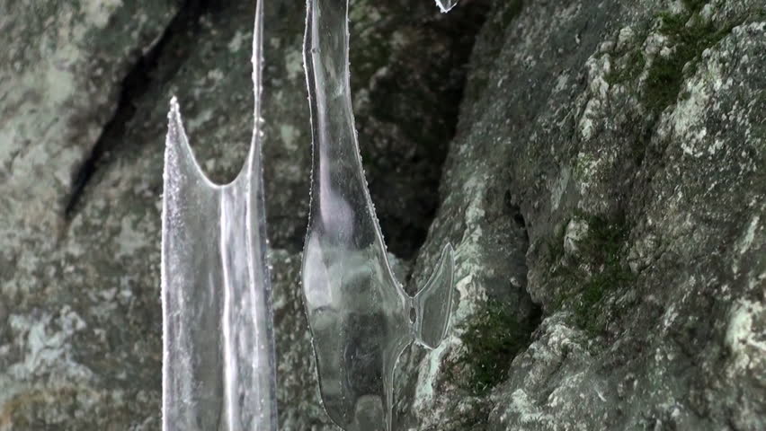 Close-up ice cave and huge icicles frost of natural glacier on Lake Baikal in Siberia.