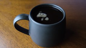 A mug of hot coffee on a table. 