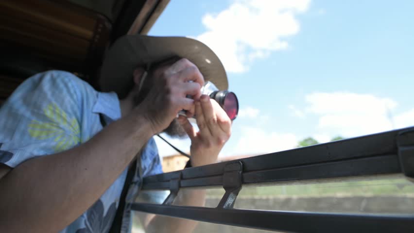 4K hipster taking pictures on vintage train