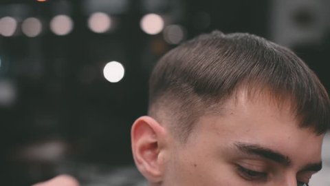 Men's haircut in barbershop. Scissor cutting.