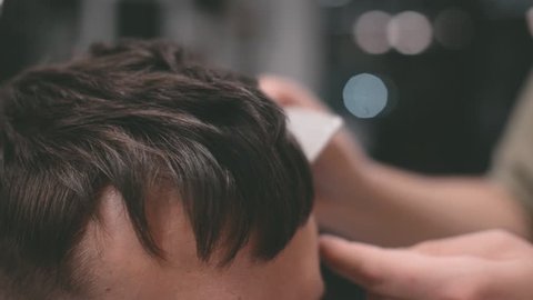 Male hairstyle in salon. Man hair style in barber shop. Finish hairdressing.