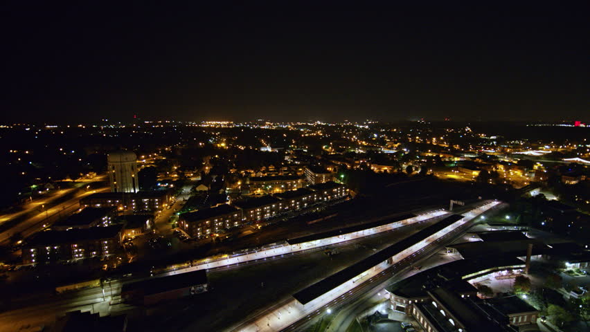 North Carolina Greensboro Aerial Panning around moving train with nighttime cityscape backdrop 10/17