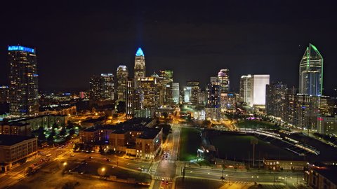 North Carolina Charlotte Aerial v49 Flying low through downtown cityscape at night 10/17