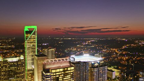 North Carolina Charlotte Aerial v46 Flying backwards through downtown cityscape with sunset sky 10/17