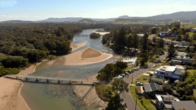 Aerial video of Crooked river and the walking bridge, Gerroa, NSW, Australia.