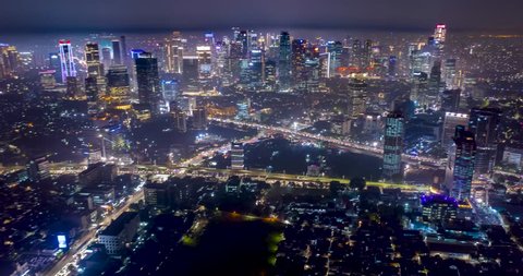 JAKARTA, Indonesia - December 20, 2018: Beautiful aerial hyperlapse of nighttime in Jakarta downtown with night lights and skyscrapers view. Shot in 4k resolution