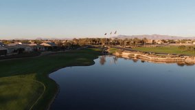 Drone footage from a golf course near a residential neighborhood in Arizona. Shot of the water hazard near the course.