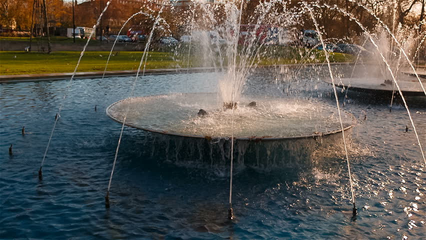 Slow motion shot of beautiful water fountains adjacent to the 19th century Marble Arch in central London, England, UK