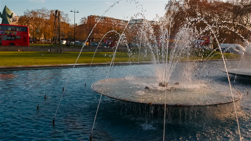 Ultra slow motion shot of beautiful water fountains adjacent to the 19th century Marble Arch in central London, England, UK
