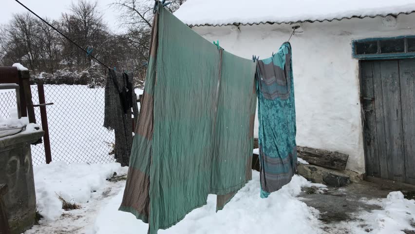 old bed linen. the sheet is hanging on the rope. Troitsk. Kiev oblast. Ukraine