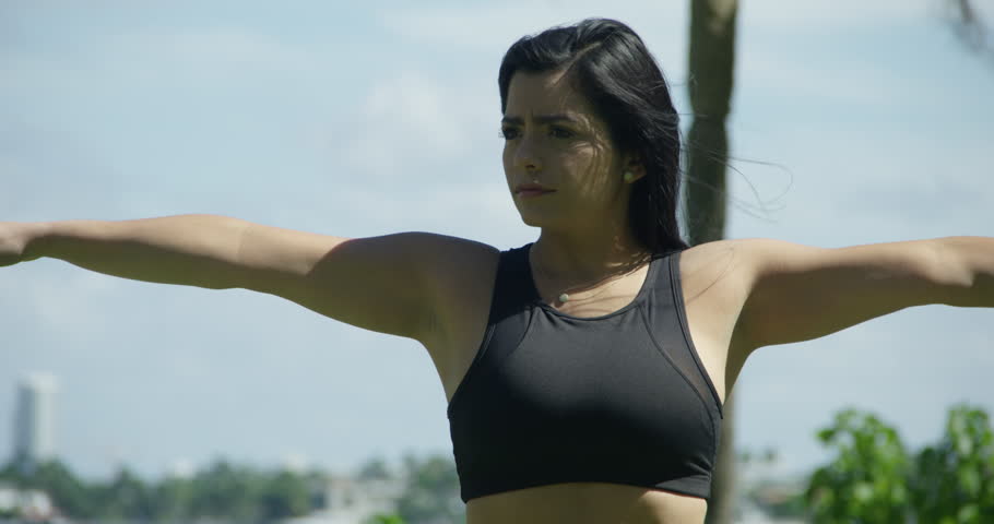 STRETCHING YOUNG FIT GIRL WORKING OUT IN FRONT OF THE OCEAN
