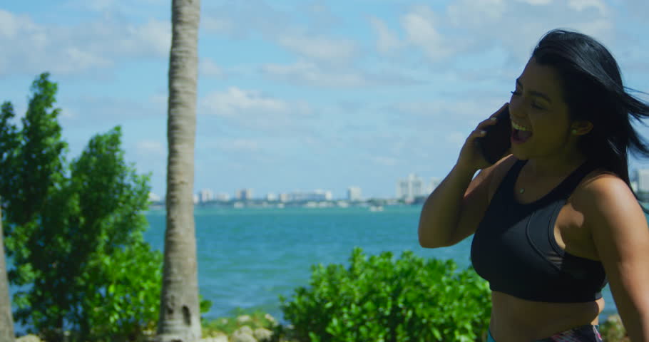 YOUNG FIT GIRL WORKING OUT IN FRONT OF THE OCEAN