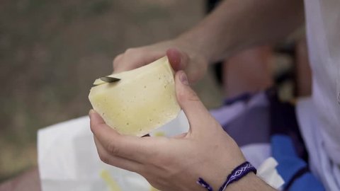 Cutting up cheese for a picnic. HD. Slow motion.