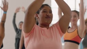 yoga class young overweight mixed race woman practicing warrior pose enjoying healthy lifestyle commitment fitness instructor teaching diverse group meditation in studio - Powered by Shutterstock - Get 15% off with code: PIKWIZARD15
