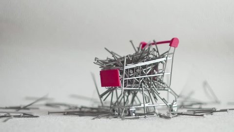 shopping cart full of large nails. concept of trading nails