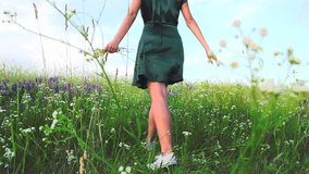 Beauty joyful girl running and spinning on field with wild spring flowers, over beautiful sky. Enjoy life Freedom concept. Happy young woman outdoors. Meadow. Allergy free concept. Slow motion 240 fps