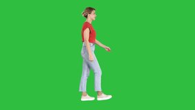 Woman in red t-shirt, jeans and sneakers walking on a Green Screen, Chroma Key. - Powered by Shutterstock - Get 15% off with code: PIKWIZARD15