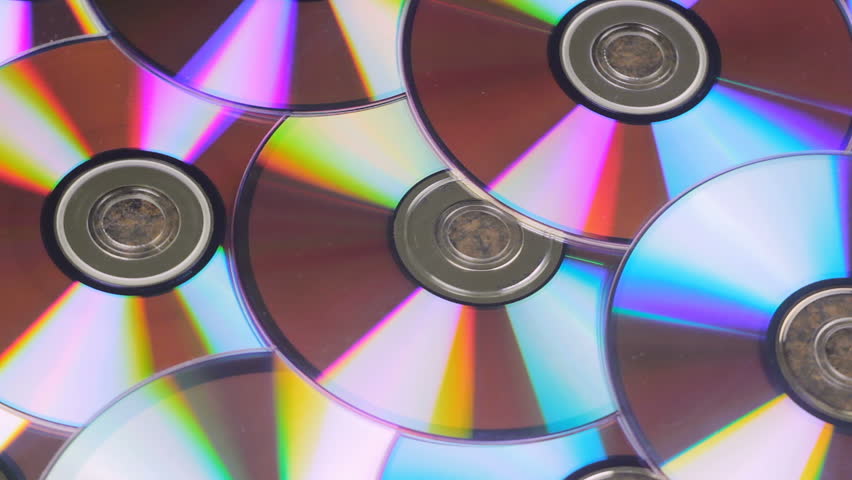 Bunch Of CD Discs Rotates Reflecting Light Royalty-Free Stock Footage #1021582171