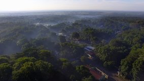 aerial drone video Guatemalan village foggy sunrise